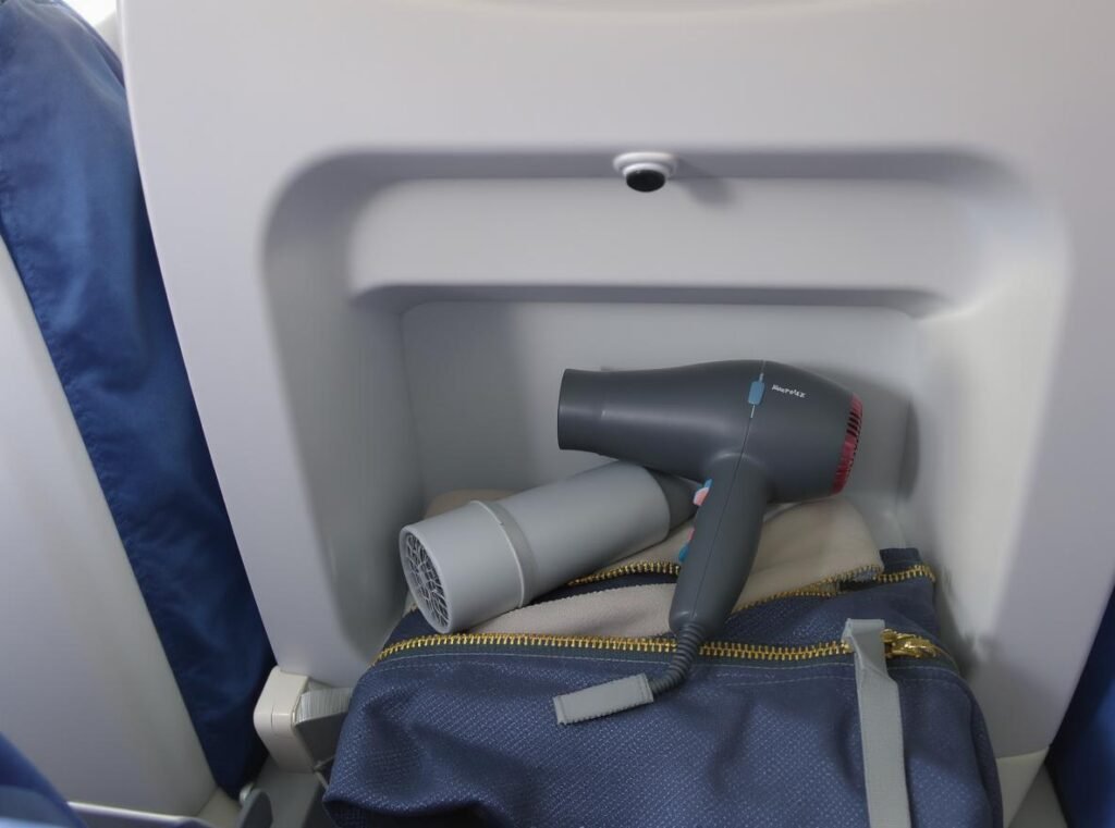 Hair dryer in airplane carry-on luggage compartment